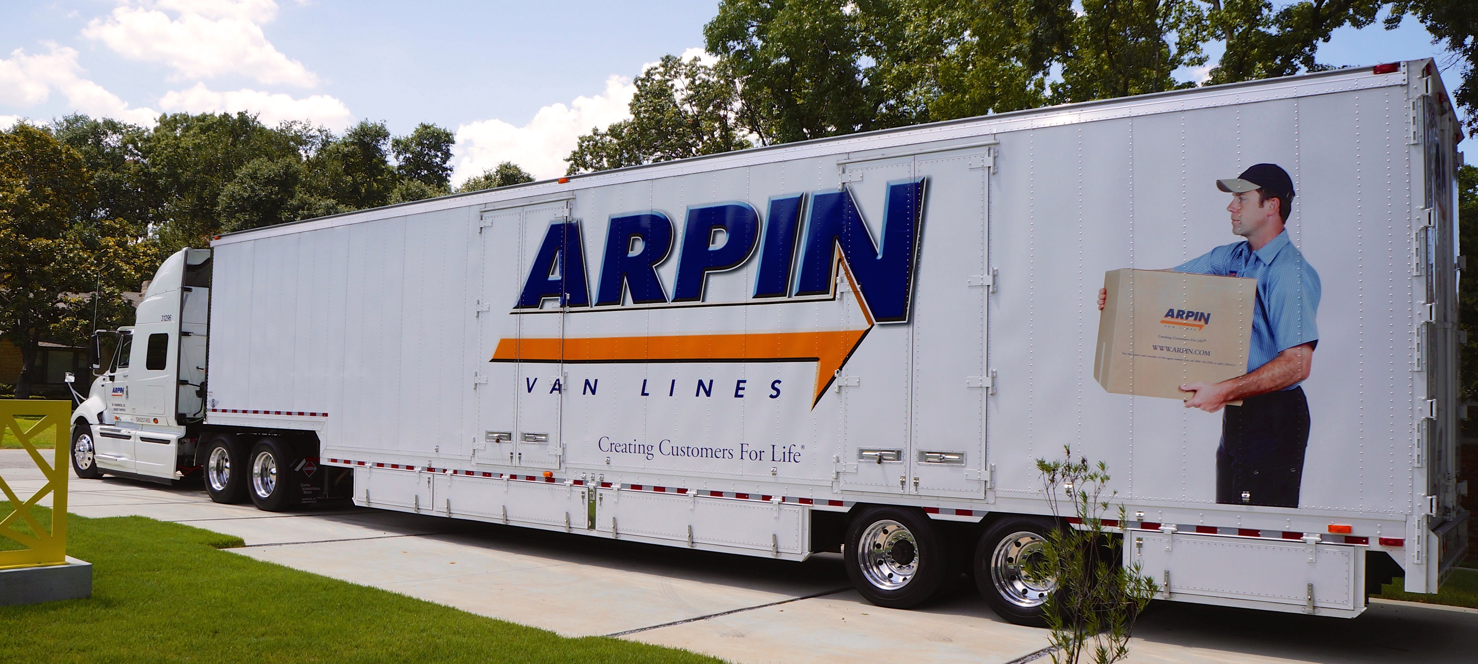 Arpin truck parked by trees