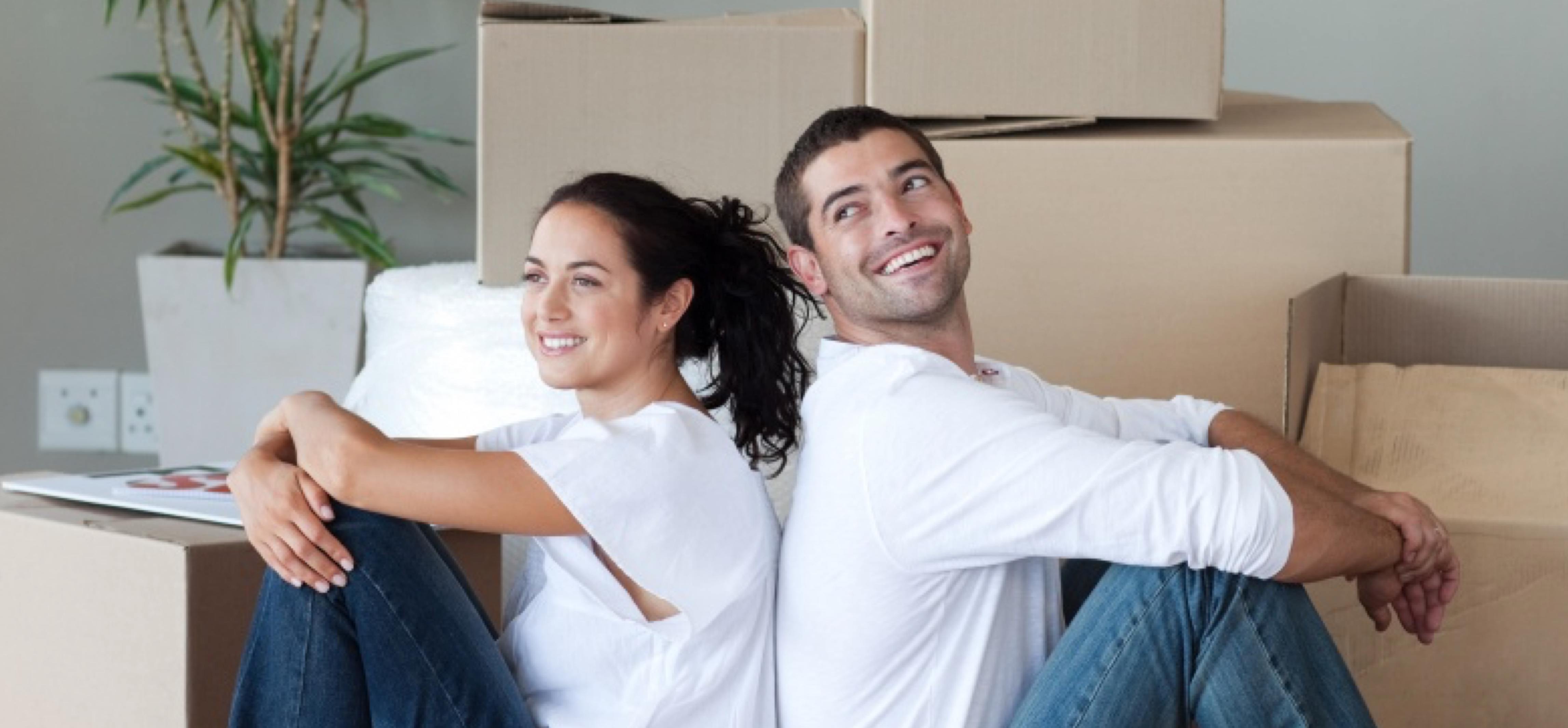 Happy couple in front of moving boxes
